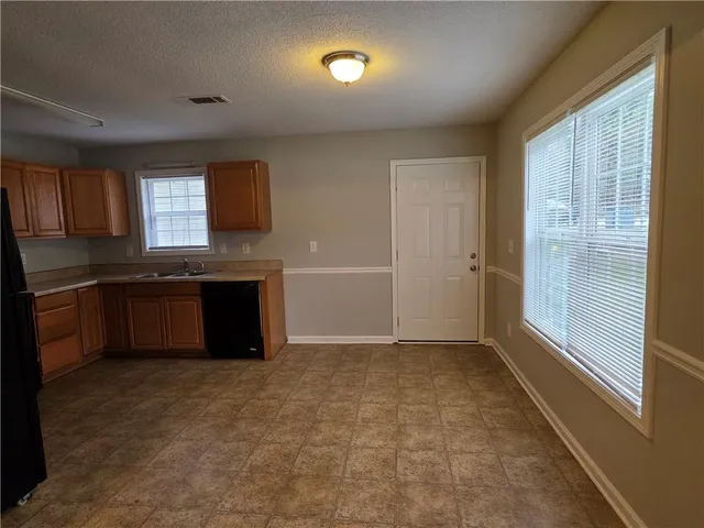 a view of kitchen with a sink and a stove top oven