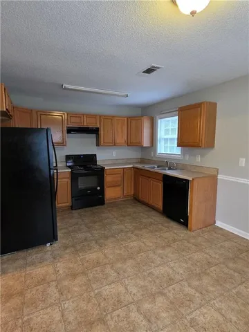 a kitchen with stainless steel appliances a refrigerator and a sink