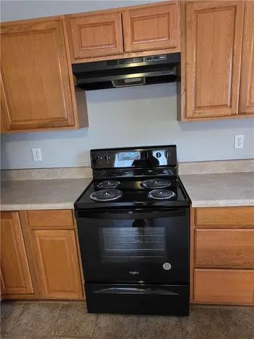 a stove top oven sitting inside of a kitchen