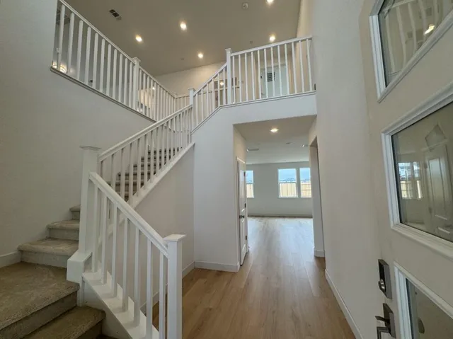 a view of entryway and hall with wooden floor