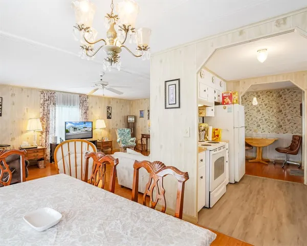 a living room with furniture wooden floor and a large window