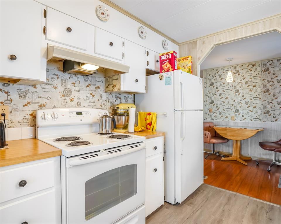 8517 Southwest 16th Place Davie, FL 33324 - Photo 2 of 28 a kitchen with a stove a refrigerator and a wooden floor