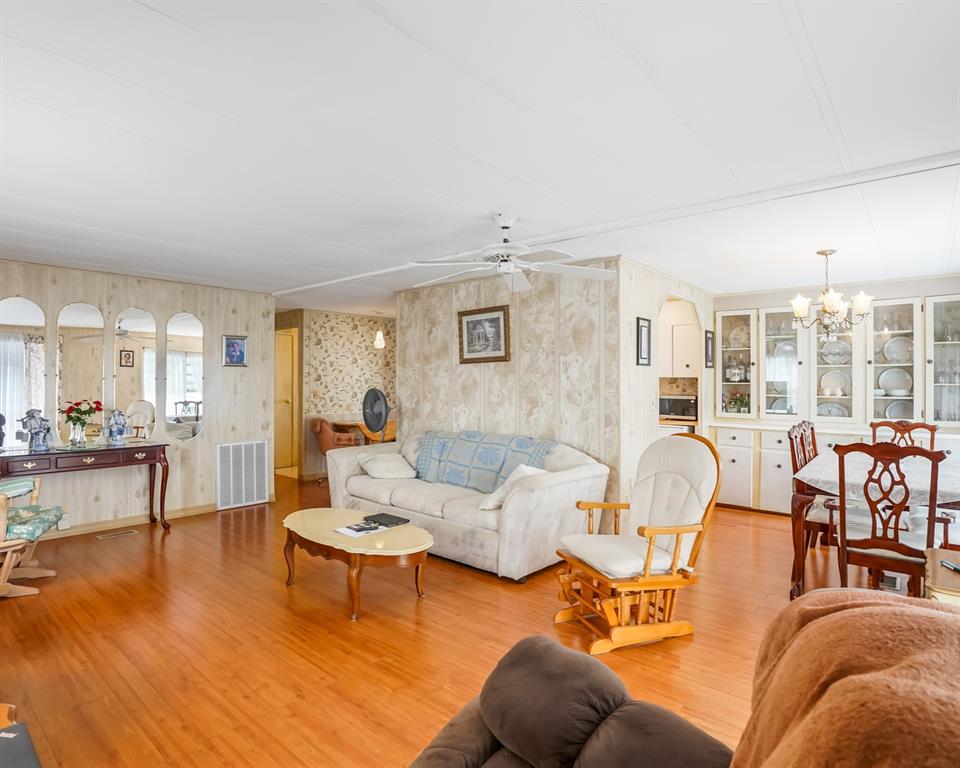8517 Southwest 16th Place Davie, FL 33324 - Photo 22 of 28 a living room with furniture wooden floor and a large window