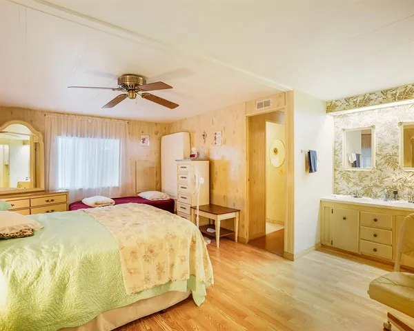 a large bedroom with a bed and a chandelier