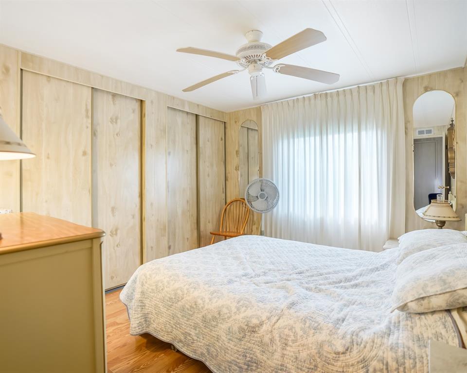 8517 Southwest 16th Place Davie, FL 33324 - Photo 26 of 28 a large bedroom with a bed and a chandelier