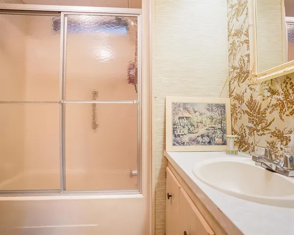 a bathroom with a bathtub and shower