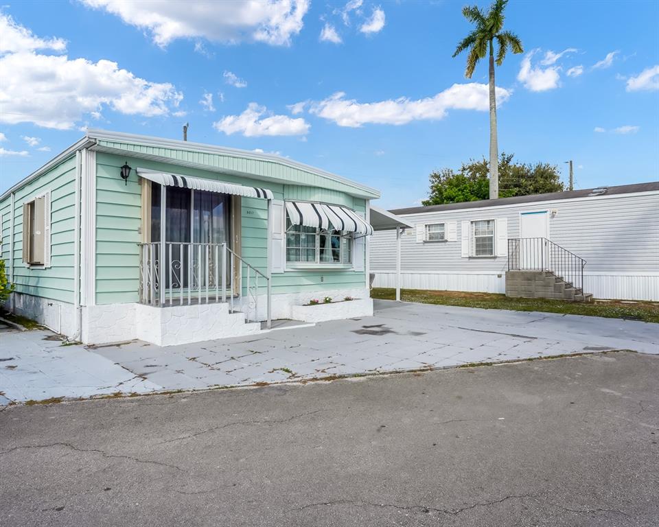 8517 Southwest 16th Place Davie, FL 33324 - Photo 10 of 28 a view of a house with wooden fence and a floor to ceiling window