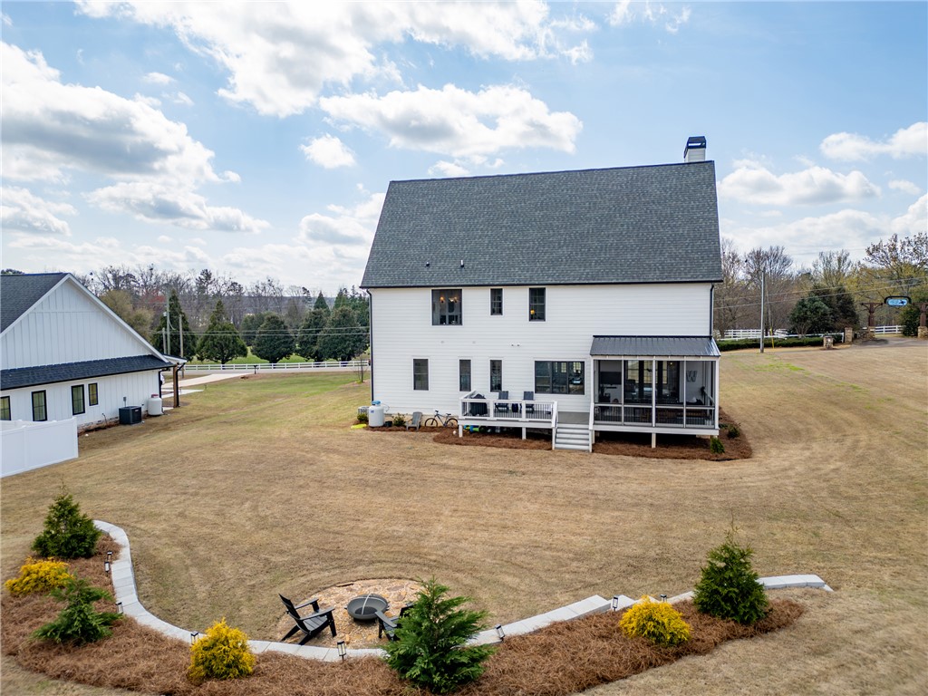 677 Lightwood Road Hartwell, GA 30643 - Photo 3 of 42 This expansive backyard features a spacious deck, screened porch, and fire pit area, perfect for outdoor enjoyment.
