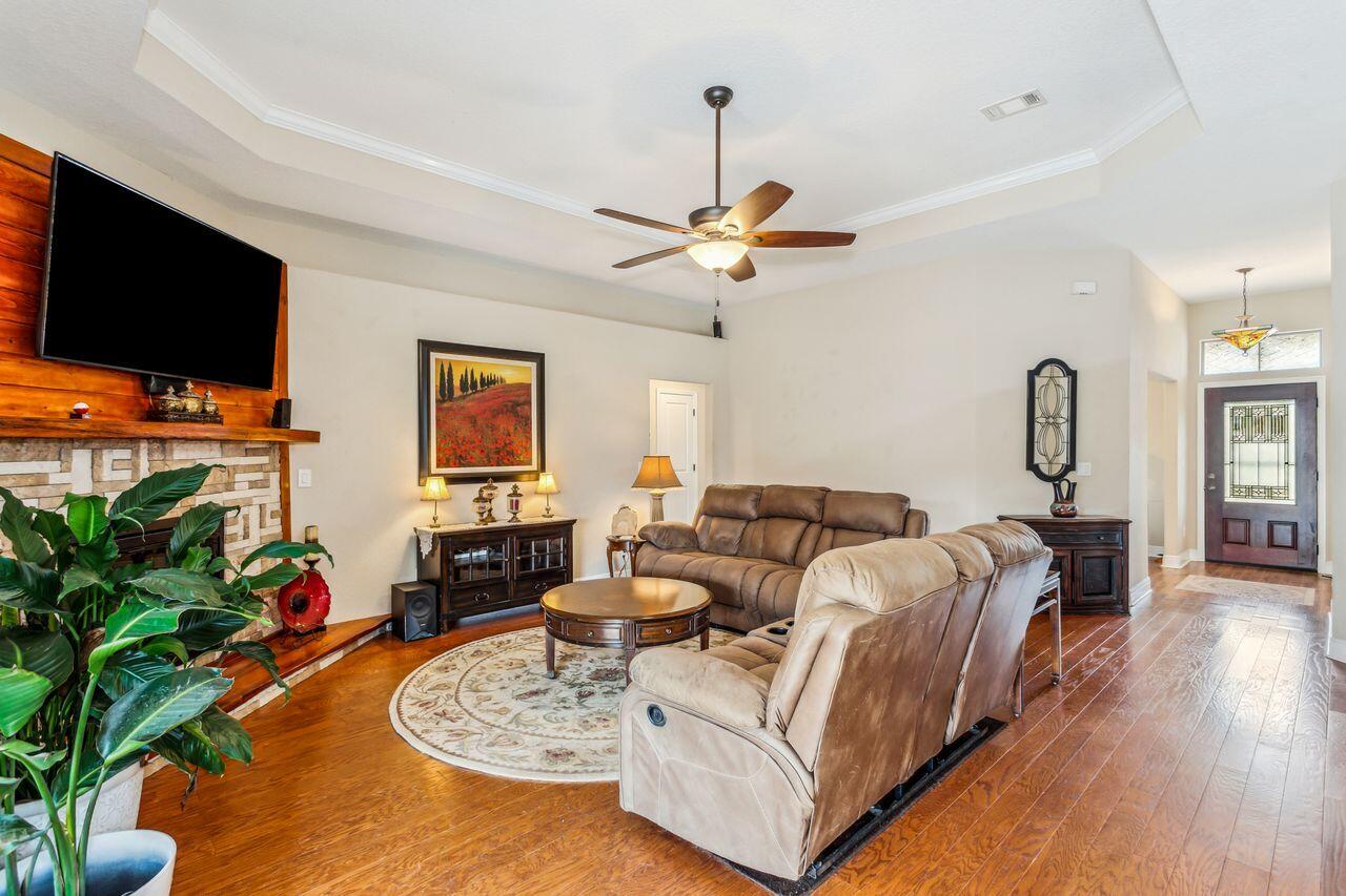 6256 Evan Circle Crestview, FL 32536 - Photo 11 of 46 a living room with furniture a flat screen tv and a potted plant