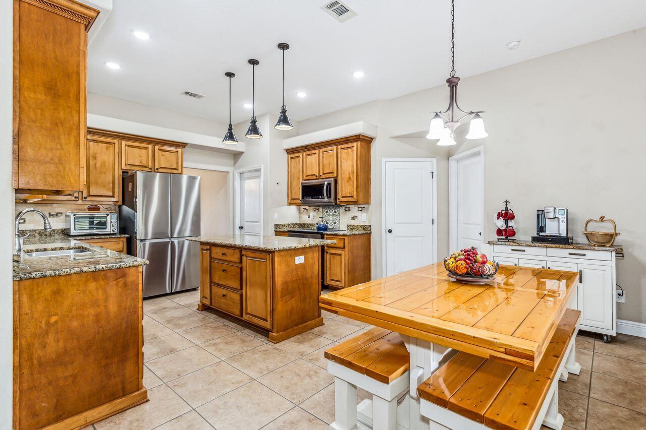 6256 Evan Circle Crestview, FL 32536 - Photo 12 of 46 a kitchen with sink refrigerator and microwave