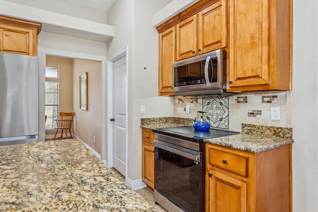 6256 Evan Circle Crestview, FL 32536 - Photo 15 of 46 a kitchen with stainless steel appliances granite countertop a stove microwave and cabinets