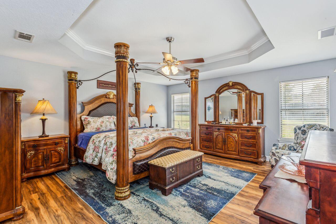 6256 Evan Circle Crestview, FL 32536 - Photo 17 of 46 a bedroom with bed and wooden floor