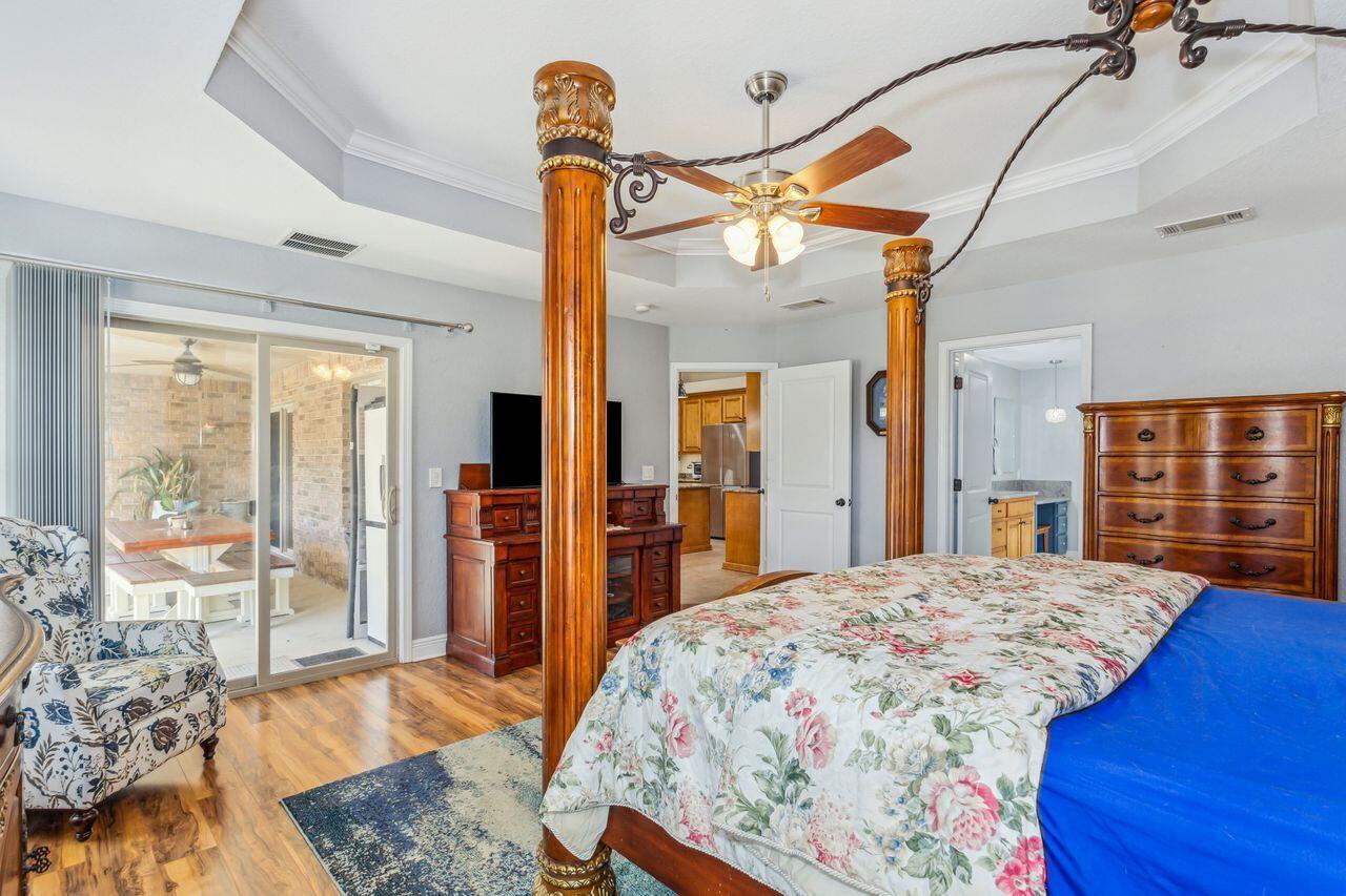 6256 Evan Circle Crestview, FL 32536 - Photo 18 of 46 a bedroom with a large bed and wooden floor