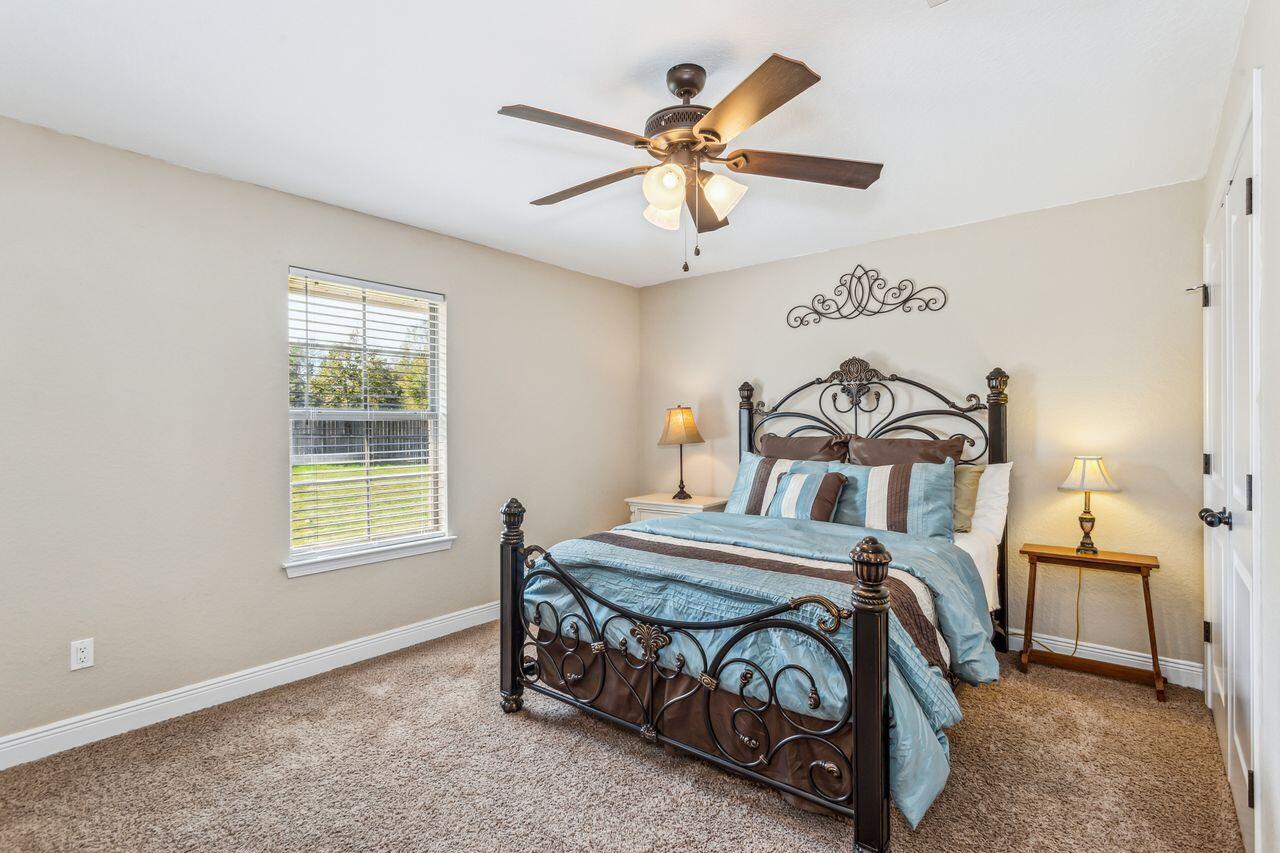 6256 Evan Circle Crestview, FL 32536 - Photo 22 of 46 a bedroom with a bed and a chandelier