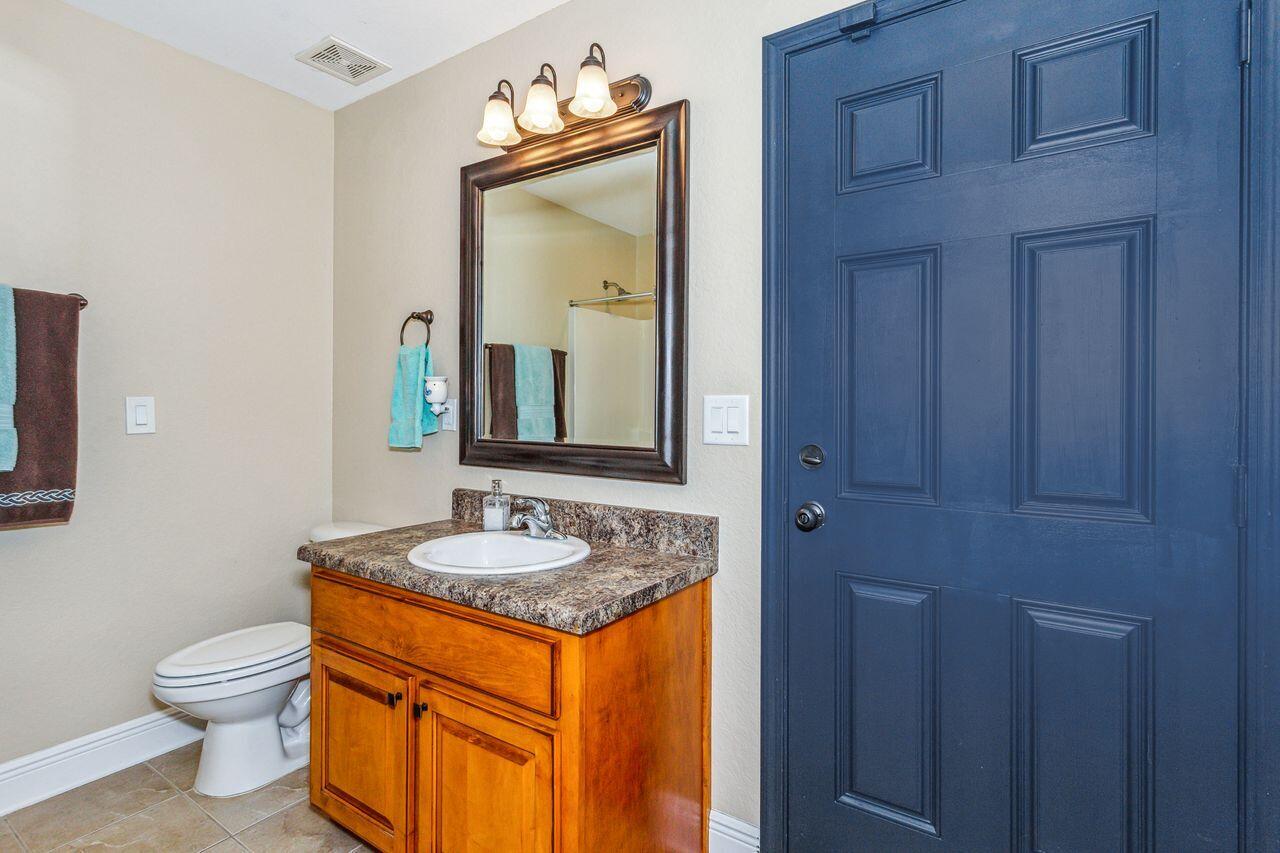 6256 Evan Circle Crestview, FL 32536 - Photo 23 of 46 a bathroom with a granite countertop sink and a mirror