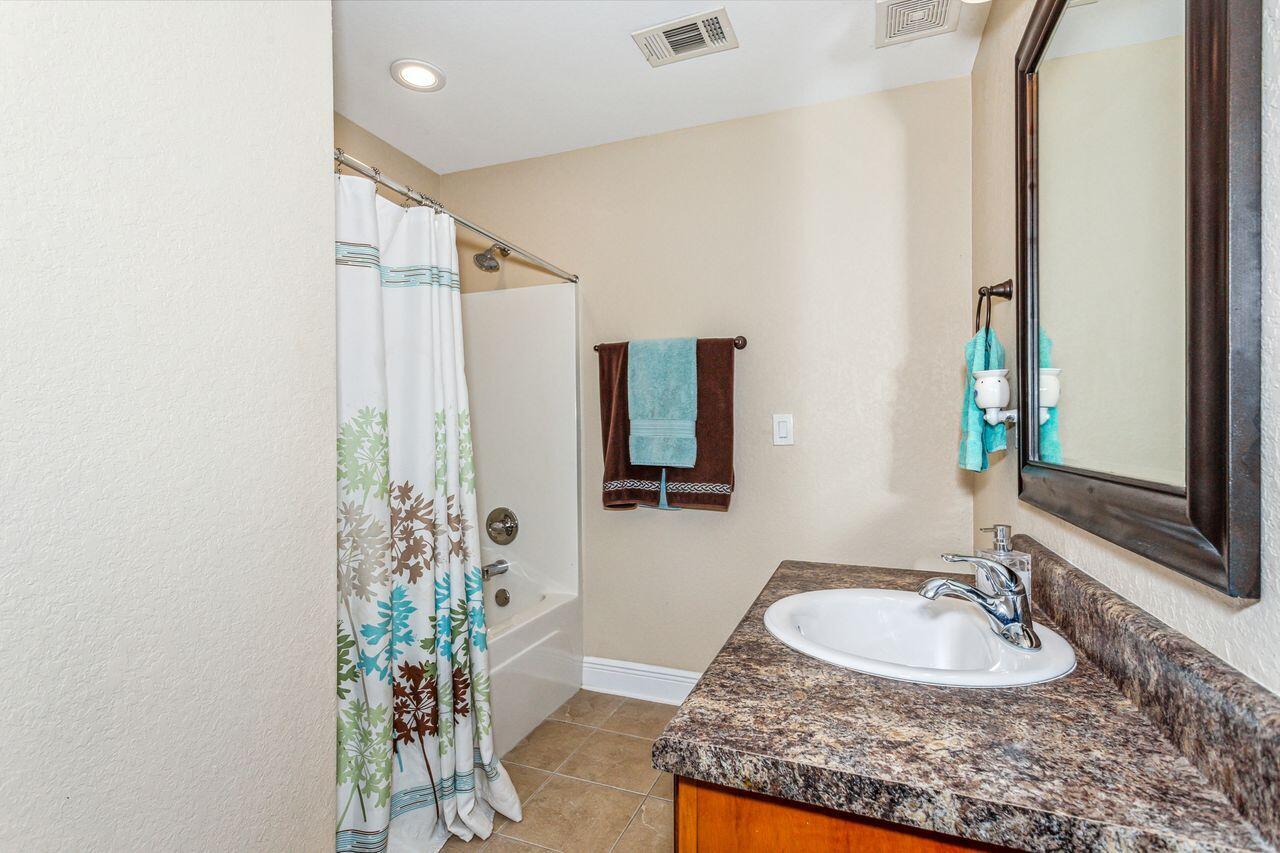 6256 Evan Circle Crestview, FL 32536 - Photo 24 of 46 a bathroom with a granite countertop sink a mirror and a shower