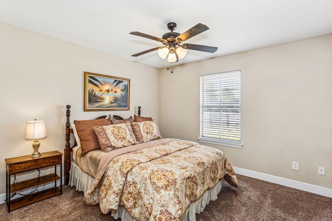 6256 Evan Circle Crestview, FL 32536 - Photo 25 of 46 a bedroom with a bed and a chandelier