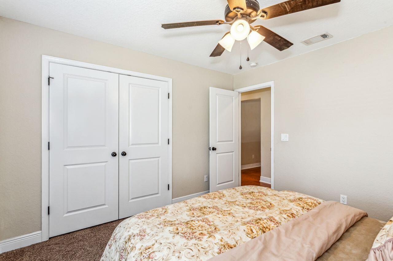 6256 Evan Circle Crestview, FL 32536 - Photo 26 of 46 a bedroom with a bed and a chandelier