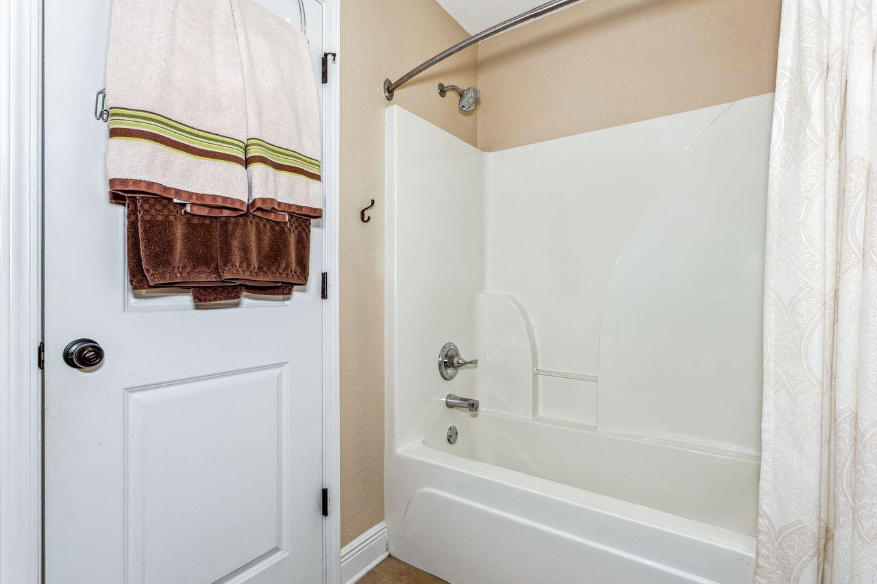 6256 Evan Circle Crestview, FL 32536 - Photo 28 of 46 a bathroom with a bathtub and a shower