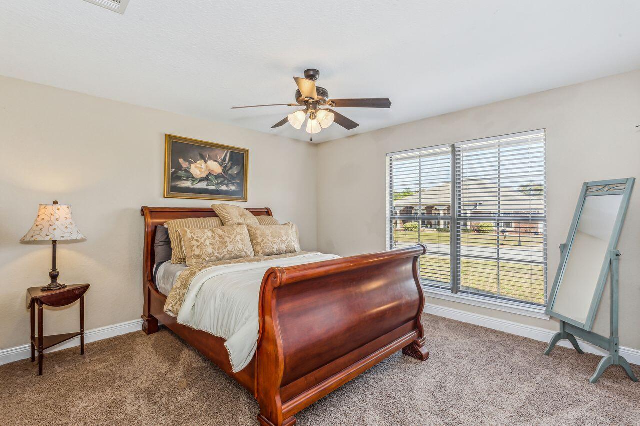 6256 Evan Circle Crestview, FL 32536 - Photo 29 of 46 a bed room with a bed and a chandelier