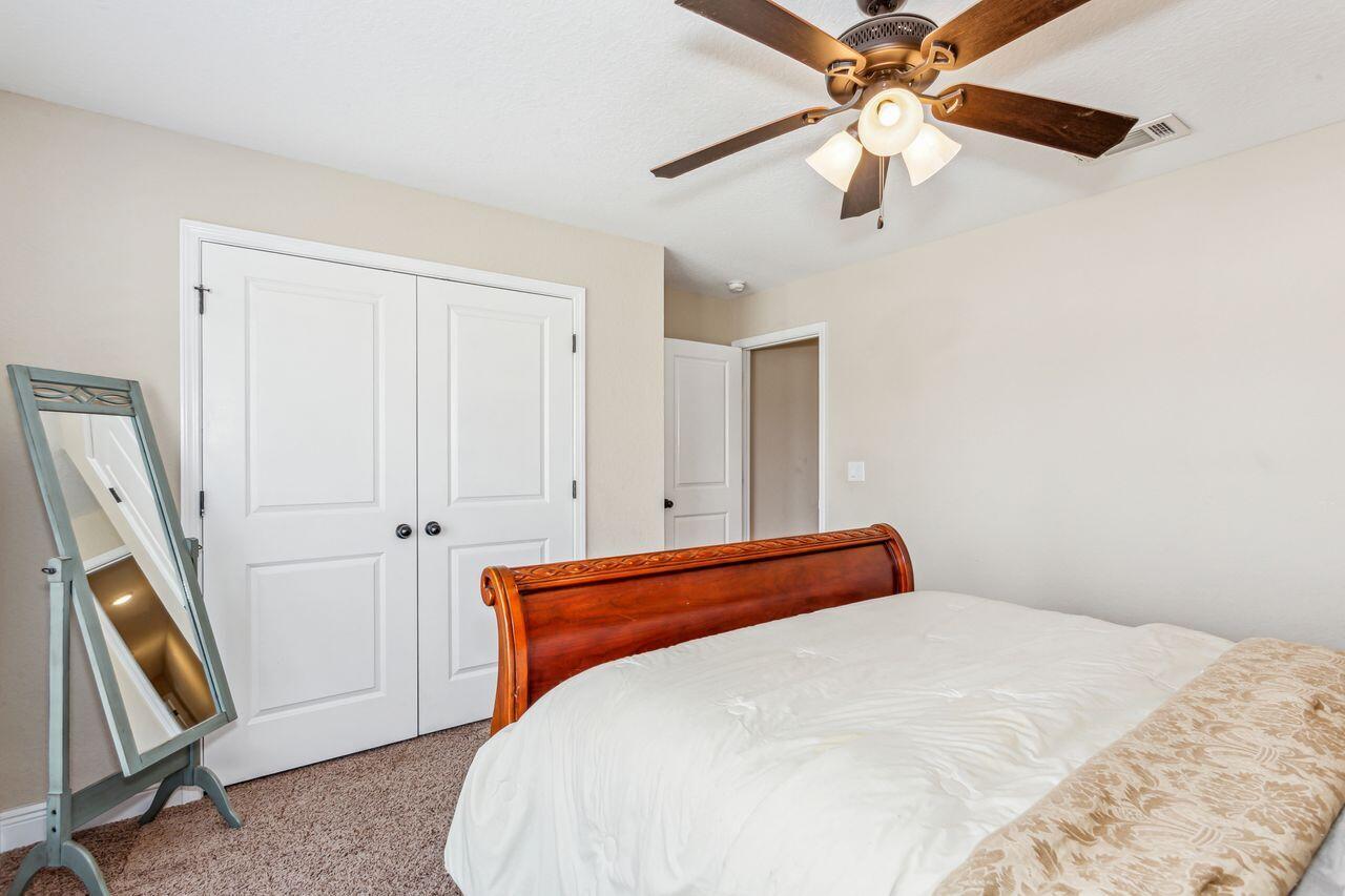 6256 Evan Circle Crestview, FL 32536 - Photo 30 of 46 a bedroom with a bed and a chandelier