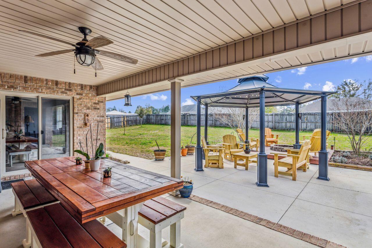 6256 Evan Circle Crestview, FL 32536 - Photo 32 of 46 a view of a patio with a table and chairs