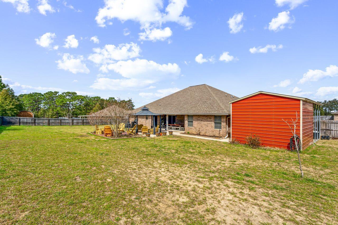 6256 Evan Circle Crestview, FL 32536 - Photo 36 of 46 a backyard of a house with table and chairs
