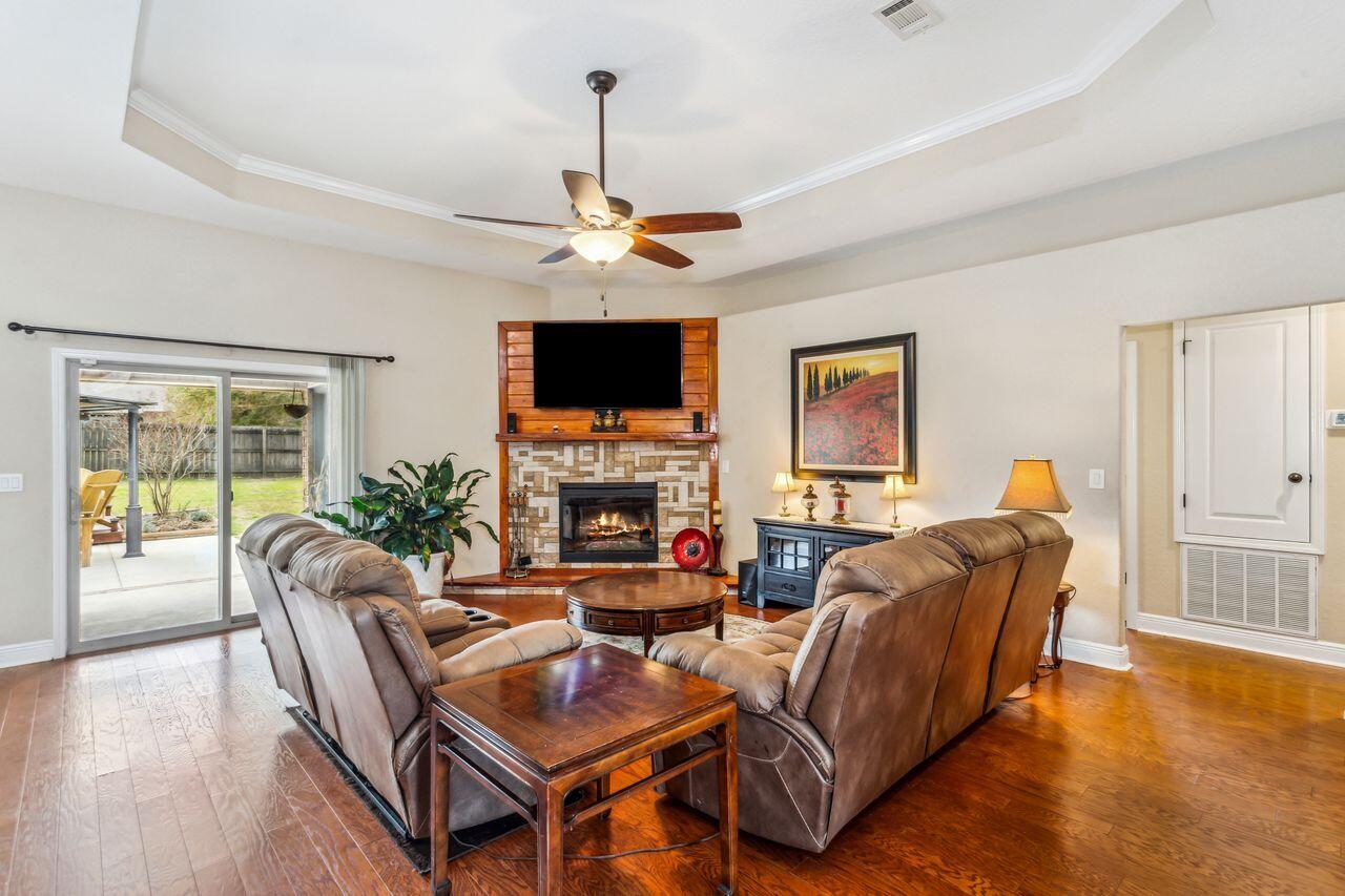 6256 Evan Circle Crestview, FL 32536 - Photo 8 of 46 a living room with fireplace furniture and a flat screen tv