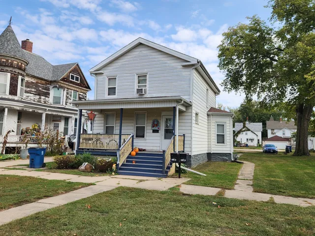 a front view of a house with a yard table and chairs
