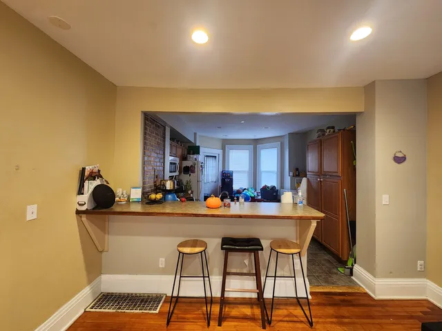a dining room with furniture and wooden floor