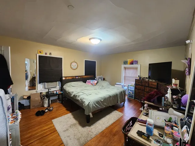 a bedroom with a bed and flat screen tv