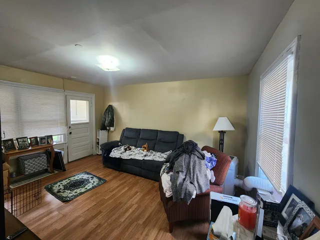 a bedroom with furniture a rug and a window