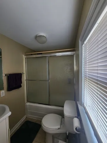 a bathroom with a toilet and a shower