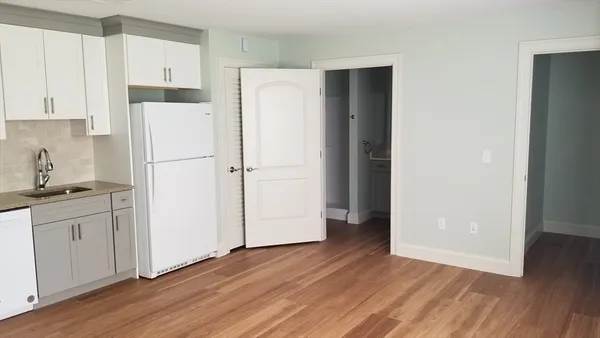 a white refrigerator freezer sitting in a kitchen