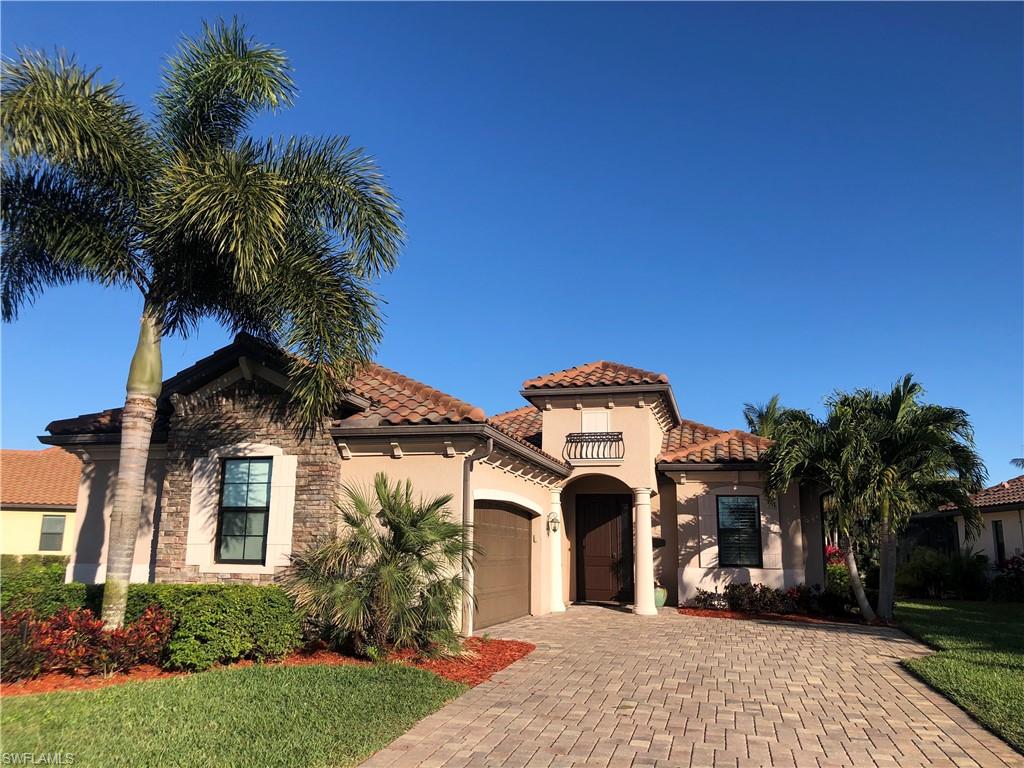 9474 Piacere Way Naples, FL 34113 - Photo 1 of 17 a front view of a house with a garden