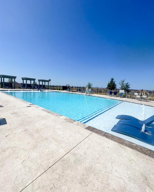 10613 Smiths Bnd Road Fort Worth, TX 76126 - Photo 29 of 29 Expansive outdoor pool area featuring a large rectangular swimming pool with integrated steps, a shallow entry area, and surrounding stamped concrete decking