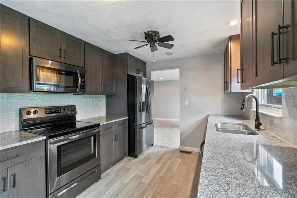 8961 Barnes Lake Road Irwin, PA 15642 - Photo 12 of 37 Kitchen renovated in 2018 complete with granite countertops, cabinetry flooring annd appliances