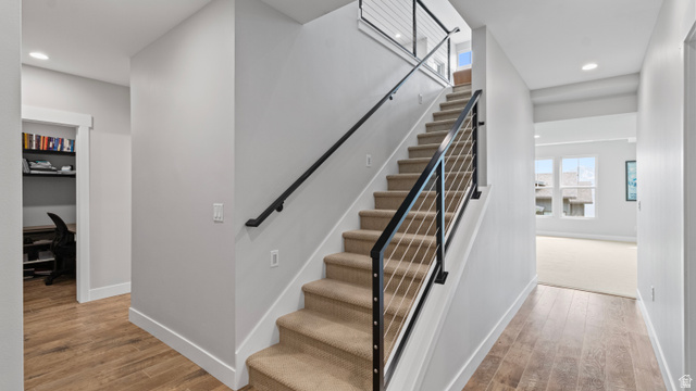 355 East Overlook Loop Hideout, UT 84036 - Photo 26 of 40 Modern staircase with cable railing, carpeted treads, and wood-finish flooring