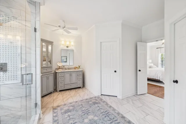 a bathroom with a granite countertop toilet and a sink