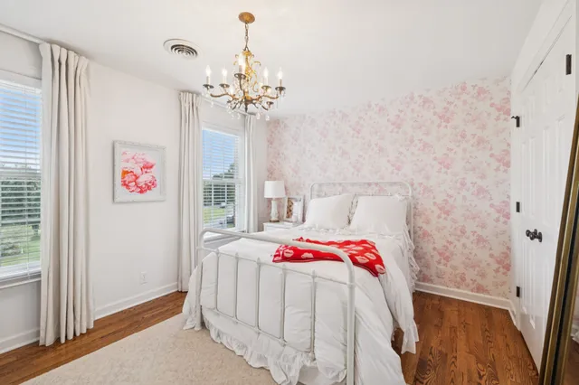 a living room with furniture a flat screen tv and a floor to ceiling window