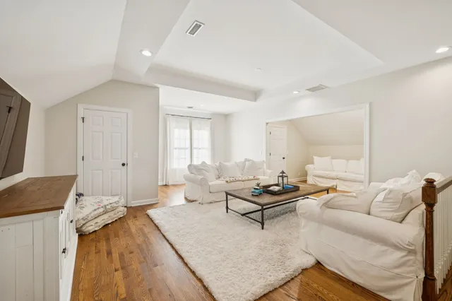 a living room with furniture and next to a window