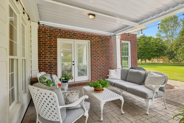 a view of a chair and table on the garden