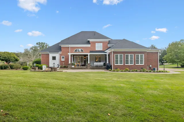 an aerial view of residential houses with outdoor space and swimming pool