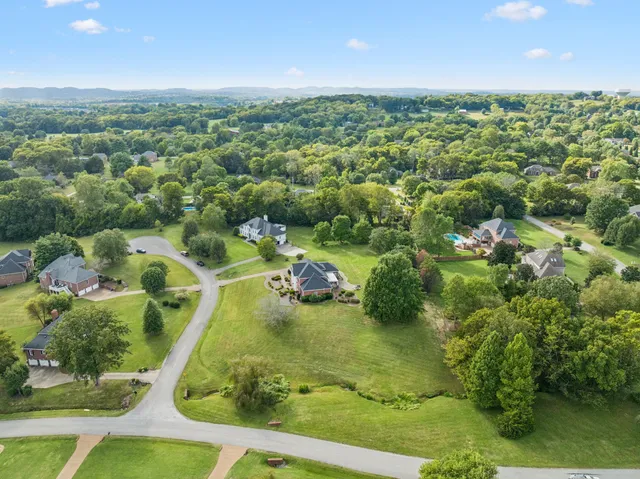 an aerial view of a house with a garden and trees