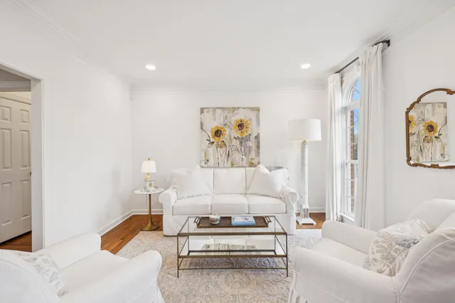 a living room with furniture and a painting