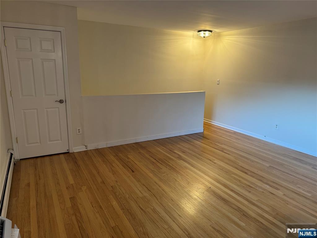 511 Washington Drive Ramsey, NJ 07446 - Photo 4 of 8 a view of an empty room with wooden floor
