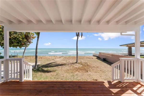 a view of a living room and floor to ceiling window kitchen dinning room