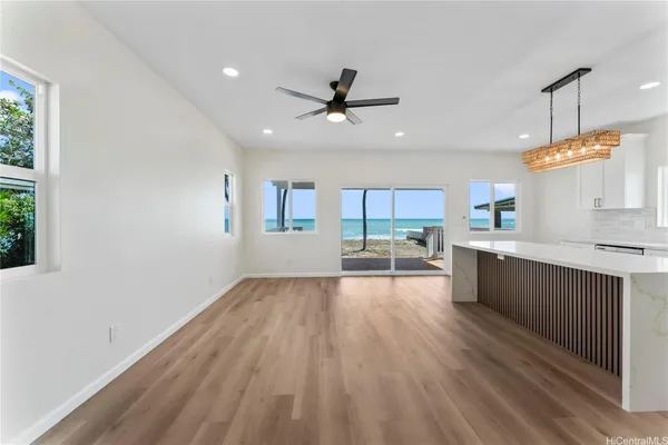 a large kitchen with kitchen island a large counter space a sink appliances and cabinets