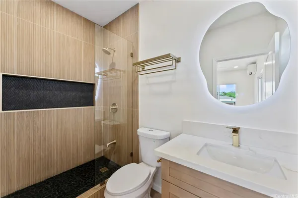 a bathroom with a sink a toilet and a mirror