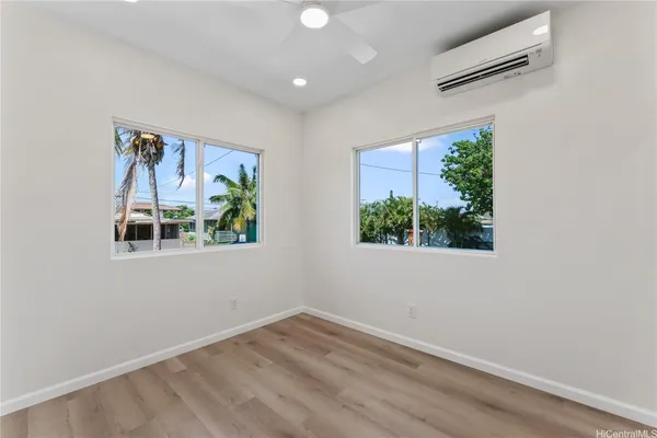 an empty room with wooden floor and a window